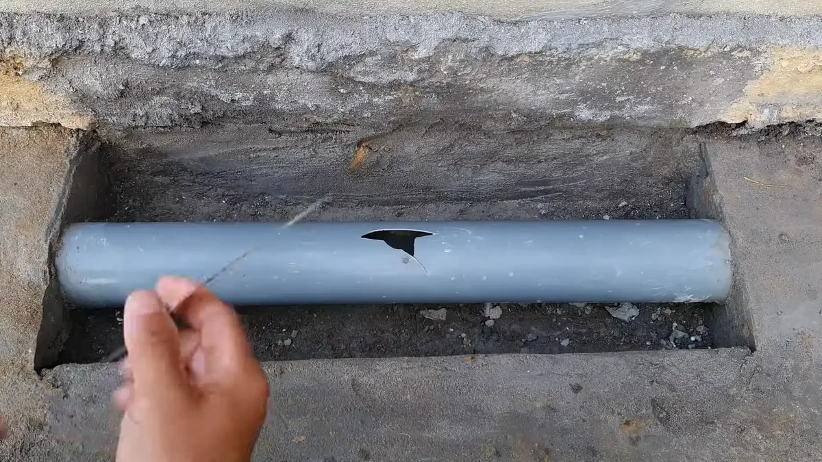 Boulder Colorado water meter box open at curb, meter face showing leak indicator dial