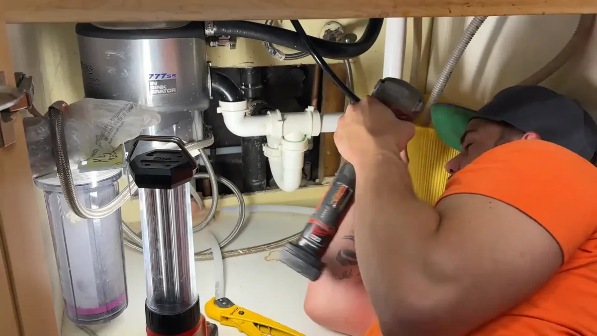 Boulder homeowner turning off main water shutoff valve to stop burst pipe emergency